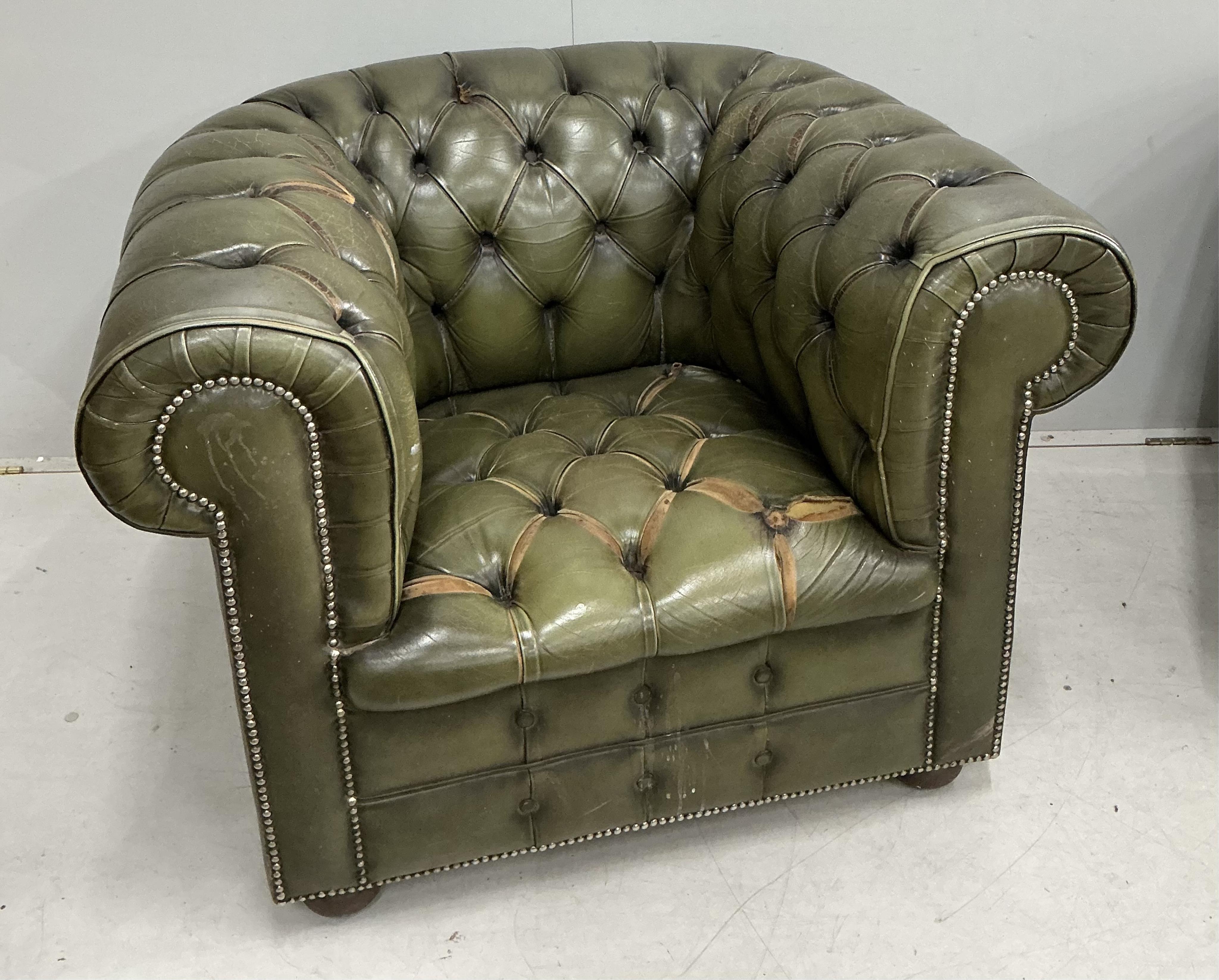 A pair of Chesterfield style buttoned green leather club armchairs, width 104cm, depth 92cm, height 74cm